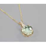 A 14ct gold, aquamarine? and diamond set pendant, on a 14ct gold fine link chain, pendant 19mm.