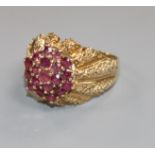 A modern 9ct gold and ruby cluster dress ring, size S.