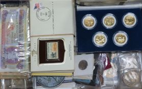 A collection of coins, banknotes and stamps, including US Morgan and Peace dollars (1882, 1898,