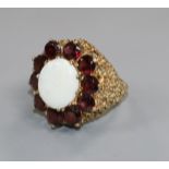 A modern 9ct gold, white opal and garnet? set oval dress ring, size L.