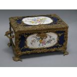 A porcelain and brass mounted casket length 39cm