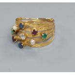 A yellow metal and multi gem set multi shank ring (a.f.), size H.