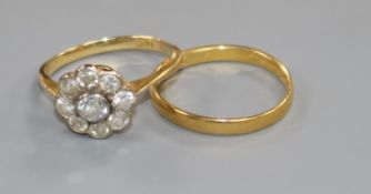 An 18ct gold and diamond cluster ring and a 22ct gold wedding band.