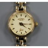 A lady's 9ct gold Rotary manual wind wrist watch, on a 9ct gold bracelet.