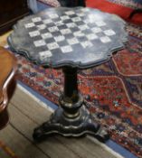 A Victorian papier mache games table, painted and gilded and inlaid with mother of pearl, raised