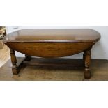 An oak drop leaf oval coffee table W.116cm