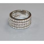 A modern white metal and four row diamond half eternity ring, size L/M.