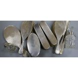A five piece silver mounted mirror and brush set, one other brush, two toilet jars, button hook