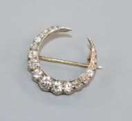 An early-mid 20th century yellow and white metal, diamond set crescent brooch, 21mm.