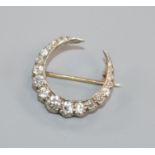 An early-mid 20th century yellow and white metal, diamond set crescent brooch, 21mm.