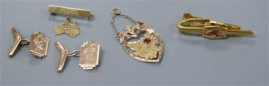 A pair of 9ct gold cufflinks with 'boomerang' terminal, a 9ct gold map of Tasmania pendant, a 9ct '