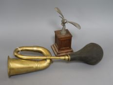 A vintage brass car horn, No 14 and a dove car mascot