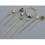 A 585 yellow metal ring and seven assorted stick pins including one 10ct.