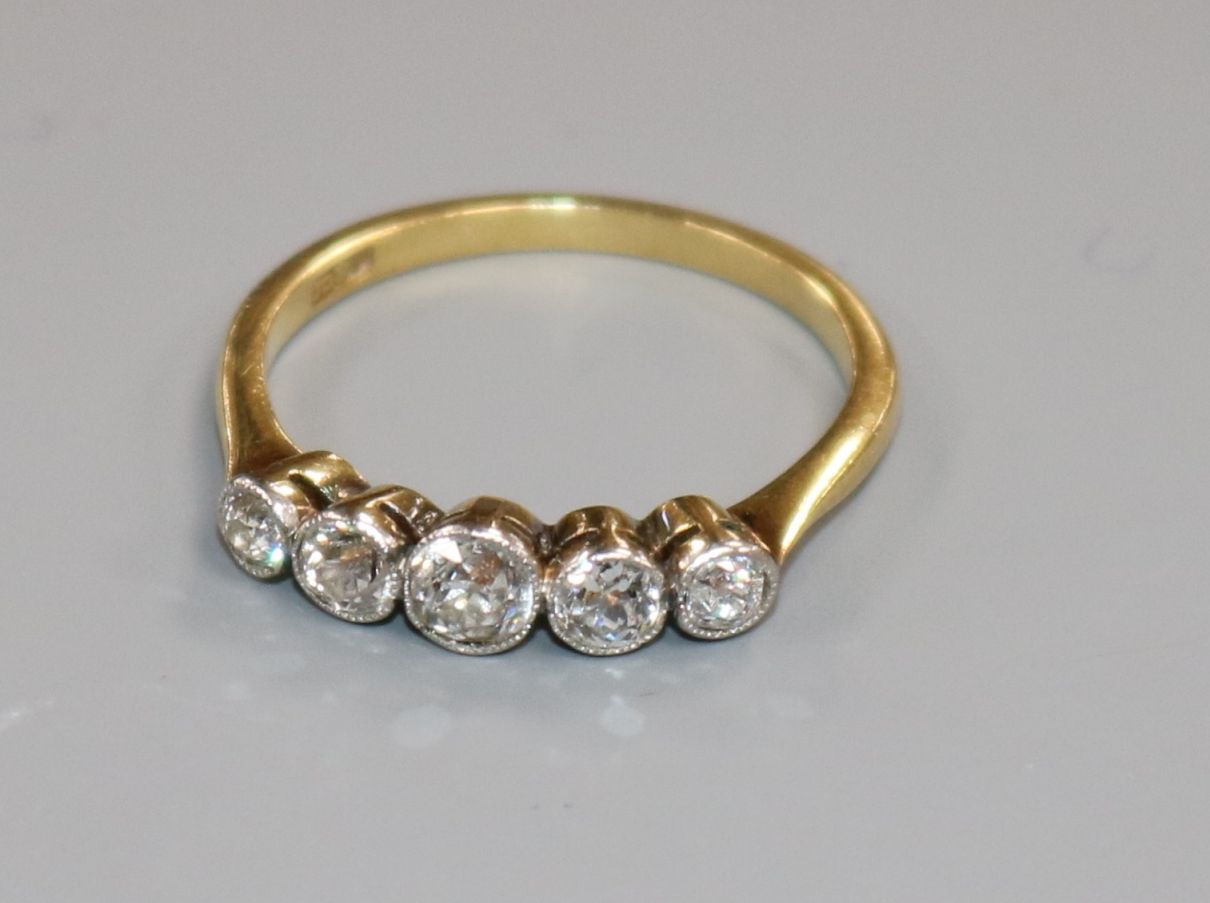 An 18ct gold and graduated five stone diamond half hoop ring, size M. - Image 2 of 2