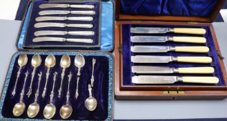 A cased set of six pairs of Edwardian ivory handled silver fish eaters and two other cased sets, one