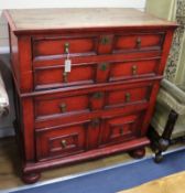 A 17th century and later red painted chest, with four long drawers, on bun feet, W.105cm