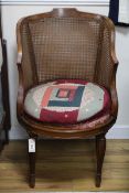 An Edwardian painted caned mahogany tub armchair