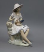 A Nao porcelain figure of a girl with a chicken, by Vicente Martinez