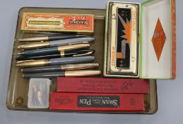 A collection of various fountain pens, two boxed and a mouth organ