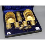 A set of six Limoges blue edged gilt porcelain coffee cans and saucers, together with a set of six