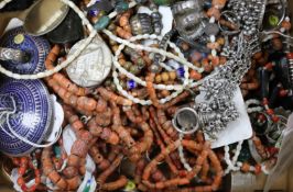 A group of assorted coral necklaces and other ethnic jewellery.