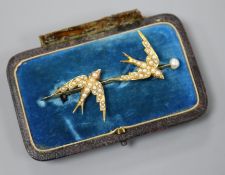 A Victorian gold and pearl bar brooch set with two swallows in flight, inscribed '8th June 1886',