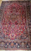 A Persian red ground rug 202 x 135cm