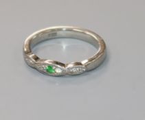 A modern platinum, green sapphire? and diamond ring,