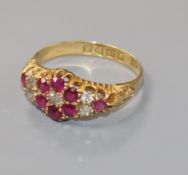 A George V 18ct gold, ruby and diamond cluster ring, size O.