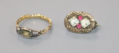 A George III yellow and white metal, enamelled mourning ring (central stone missing) and a 19th