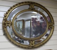 A 19th century giltwood and gesso oval marginal plate mirror W.100cm