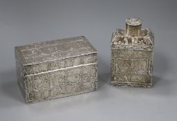 A 19th century German? oblong white metal tea canister and cover (a.f), embossed with figures and