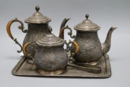 A four piece tea and coffee set with tongs