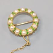 An Edwardian yellow metal, demantoid garnet and seed pearl circular open work brooch, with safety