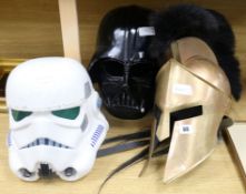 A Darth Vader helmet, Storm Trooper helmet and Roman helmet