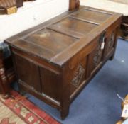 An 18th century carved oak coffer W.130cm