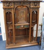 An Ecclestastical marble mounted carved walnut cabinet W.106cm