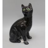A Bretby ceramic black cat with glass eyes height 34cm