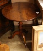 An early 19th century mahogany circular tilt top tea table, on turned pillar and splayed support,