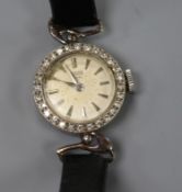 A lady's 1960's 9ct white gold Tudor manual wind wrist watch with diamond set bezel, with associated