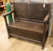 A carved oak settle