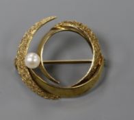A 14ct plain and textured yellow gold openwork spiral form brooch set with a single cultured