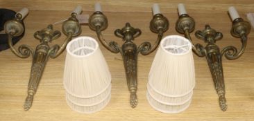 A set of three brass two branch wall lights