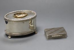 A silver oval table musical box, a table bell and a Garrard & Co silver and gold pill box