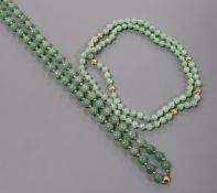 A jade bead necklace comprising 60 uniform beads with yellow metal spacers and another similar