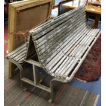 A mid 20th century two-sided slatted garden bench