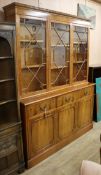 A George III style yew veneered bookcase cupboard W.155cm