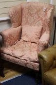 A Regency upholstered wing armchair