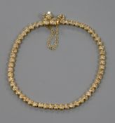 An 18ct gold and diamond set tennis bracelet.
