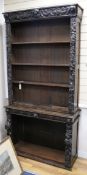 A Victorian carved oak bookcase W.110cm